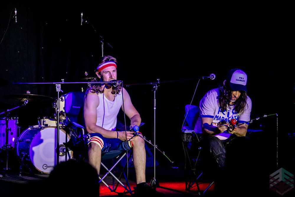 Two characters in headbands on camp chairs