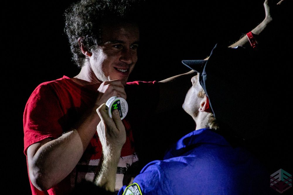 A volunteer on stage with a cop